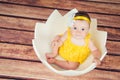 Cute little girl in the egg basket. View from above Royalty Free Stock Photo