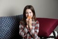 a cute little girl emotionally eating a hamburger, sandwich, cheeseburger or burger and smiling at home