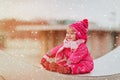 Cute little girl enjoy first snow in the city, winter fun Royalty Free Stock Photo