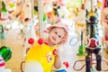 Cute little girl enjoying in funfair and riding on colorful carousel house Royalty Free Stock Photo