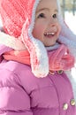 Cute little girl enjoying winter and snow dressed in warm bright Royalty Free Stock Photo