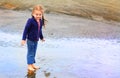 Cute little girl explores beach Royalty Free Stock Photo