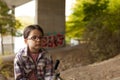 Cute little girl with eyeglasses sitting on a bicycle in the park Royalty Free Stock Photo