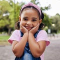 Cute little girl, face and portrait smile in adorable pink casual fashion with denim at the outdoor park. Happy girly