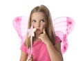 Cute little girl in fairy costume with pink wings and magic wand on white background Royalty Free Stock Photo