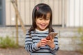 Cute little girl fascinated by a mobile phone