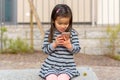 Cute little girl fascinated by a mobile phone