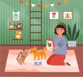 Cute little girl is feeding her cat at home Royalty Free Stock Photo