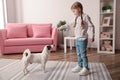 Cute little girl feeding her dog at home. Childhood pet Royalty Free Stock Photo