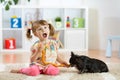 Cute little girl is feeding sausages to her dog Royalty Free Stock Photo