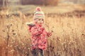 Cute little girl in a field at sunset