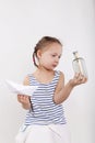 Cute little girl find secret message in glass bottle