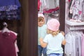 Cute little girl fiting on clothes in the shop. Royalty Free Stock Photo