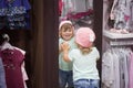 Cute little girl fiting on clothes in the shop. Royalty Free Stock Photo