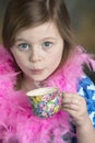 Cute little girl with floral tea cup Royalty Free Stock Photo