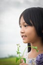 A cute little girl with a flower in her hand. Royalty Free Stock Photo