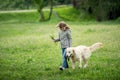 Cute little girl with flowers walking dog Royalty Free Stock Photo