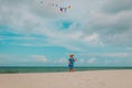 Cute little girl flying a kite at sky on beach Royalty Free Stock Photo