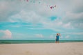 Cute little girl flying a kite at sky on beach Royalty Free Stock Photo