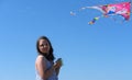 Cute little girl flying rainbow kite on sea beach Royalty Free Stock Photo