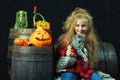 Cute little girl in the form of a witch with pumpkins