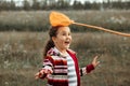 Cute little girl with friends catching butterflies and bugs with her scoop-net. Child caught in the net Royalty Free Stock Photo