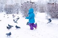 Cute little girl frightening pigeons