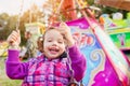 Cute little girl at fun fair, chain swing ride Royalty Free Stock Photo