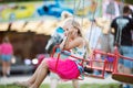 Cute little girl at fun fair, chain swing ride Royalty Free Stock Photo