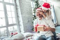 Cute little girl is giving her handsome father a gift box Royalty Free Stock Photo