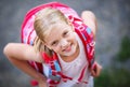 Cute little girl going home from school with her backpack