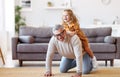 Cute little girl granddaughter playing and having fun with active positive grandfather at home Royalty Free Stock Photo