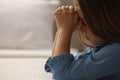 Cute little girl with hands clasped together saying bedtime prayer in bedroom. Space for text Royalty Free Stock Photo