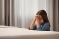 Cute little girl with hands clasped together saying bedtime prayer in bedroom. Space for text Royalty Free Stock Photo