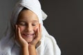 Adorable little girl happy smiling after spa bath on a white bath towel head Royalty Free Stock Photo