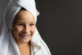 Addorable little girl happy smiling after spa bath on a white bath towel head Royalty Free Stock Photo