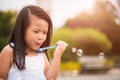 Cute little girl having fun with blowing soap bubbles Royalty Free Stock Photo