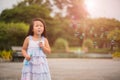 Cute little girl having fun with blowing soap bubbles Royalty Free Stock Photo
