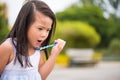 Cute little girl having fun with blowing soap bubbles in summer Royalty Free Stock Photo