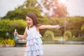 Cute little girl having fun with blowing soap bubbles in summer Royalty Free Stock Photo