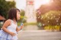 Cute little girl having fun with blowing soap bubbles Royalty Free Stock Photo