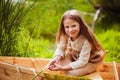 Cute little girl having fun in a boat by a river Royalty Free Stock Photo