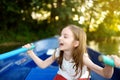 Cute little girl having fun in a boat by a river Royalty Free Stock Photo