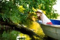 Cute little girl having fun in a boat by a river Royalty Free Stock Photo