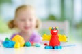 Cute little girl having fun with colorful modeling clay at a daycare. Creative kid molding at home. Royalty Free Stock Photo