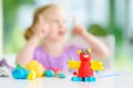 Cute little girl having fun with colorful modeling clay at a daycare. Creative kid molding at home. Royalty Free Stock Photo