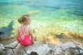 Cute little girl having fun at Emplisi Beach, picturesque stony beach in a secluded bay, with clear waters popular for snorkelling Royalty Free Stock Photo