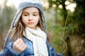 Cute little girl having fun during forest hike on beautiful spring day. Child exploring nature Royalty Free Stock Photo