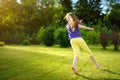 Cute little girl having fun on a grass on the backyard on sunny summer evening Royalty Free Stock Photo