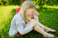 Cute little girl having fun on a grass on the backyard on sunny summer evening Royalty Free Stock Photo